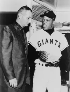 Willie Prints: Willie Mays talks to sportscaster Charles Einstein in a 1963 locker room interview
