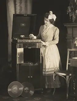 Model Prints: Woman beginning to play a phonograph in 1908