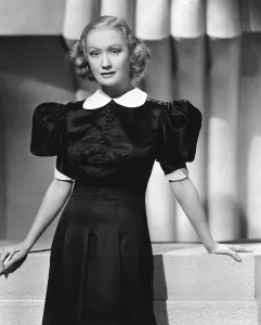 Peter Pan Collar Prints: WOMAN CHASES MAN, Miriam Hopkins, in a black satin dress by Omar Kiam, 1937