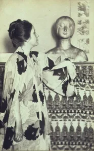 Woman in a kimono standing looking at a sculpted bust, photograph by Eva Watson Schutze, 1900