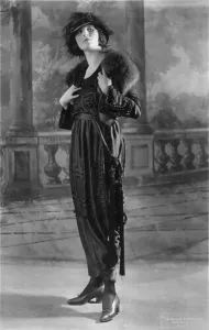 Backdrop Prints: Woman modeling dress, a frock of Moon Glo Satin, photograph 1919