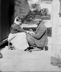 Images Dated 28th February 2008: Woman being tattooed by a man in a fez