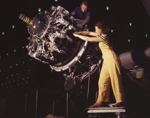 Machinery Prints: Woman war worker performing precise aircraft engine installation detail