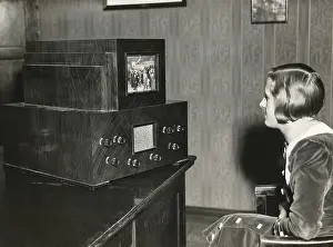 Broadcasting Prints: Woman watching a German television with a 14 x 18 centimeter screen