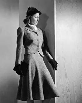 Purse Prints: Woman's suit with a short narrow waisted jacket and emphatically padded shoulders