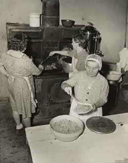 Aprons Prints: Women cooking spaghetti and frying chicken on an old stove for the Grape Festival