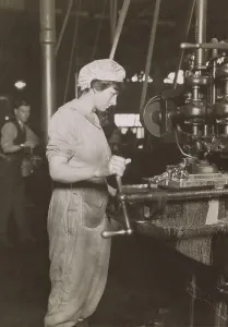 Labor Prints: Women at a long bench working on engine parts at a Lincoln Motor Company