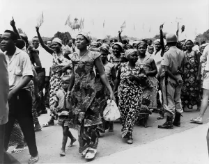 Kinshasa Prints: Women and men parade through the streets of Leopoldville in the Belgian Congo celebrating their forthcoming