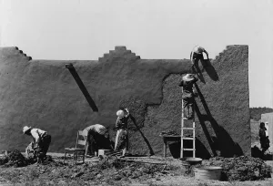 Plaster Prints: Women replastering an adobe house