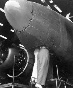 Slacks Prints: Two women workers standing through the bombardier's hatch at the Vega aircraft plant