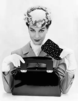 Purse Prints: Women's accessories include a square cut, top opening, black patent leather purse