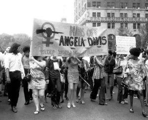 Afro Prints: Women's Liberation marchers carrying a banner in support of fugitive black militant Angela Davis