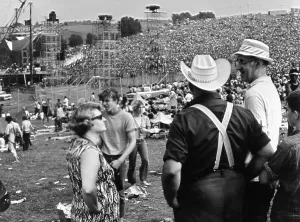 Spectator Prints: WOODSTOCK, farmer Max Yasgur (right) looks on with neighbors as his grounds are used as site for Woodstock Festival