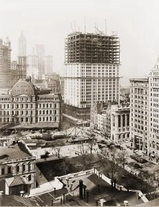 Financial District Prints: Woolworth Building, partially-constructed building amidst smaller buildings