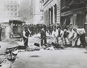 Wall Street Prints: Workers sweeping up rubble and broken glass following Wall St. Bombing of Sept. 16, 1920