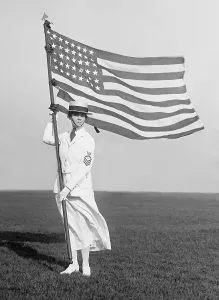 December Prints: World War 1 era US Navy Yeoman in white summer dress holding American Flag