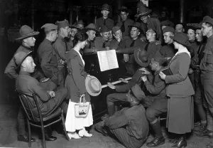 December Prints: World War I American soldiers singing around the piano at the Y