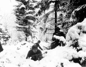 Us Army Prints: World War II. US Army infantrymen take cover in the snow in the Ardennes
