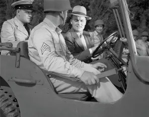 Jeep Prints: World War II, George Woolslayer (right) examining an army jeep at the post where Sergeant French L