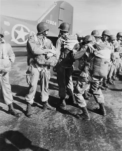 Inspecting Prints: World War II, U.S. paratroopers inspecting parachutes before taking off on maneuvers in England