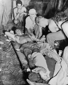 Stretcher Prints: A wounded American soldier gets a blood transfusion in New Guinea jungle