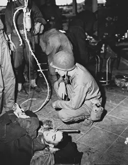 Treatment Prints: A wounded Marine is given whole blood by a medic at Yellow Beach Inchon