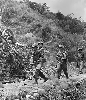 Cigarettes Prints: Wounded South Korean soldier carried to a first aid station by a U