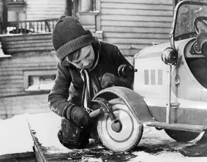 Toys Prints: A young boy playing with a toy car, 1936.. Courtesy: CSU Archives / Everett Collection