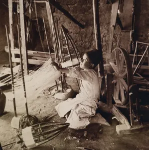 Syria Prints: Young boy unwinding silk cocoons and reeling silk threads with pre-industrial tools in his Syrian home in 1914
