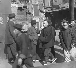 Sidewalk Prints: Young Chinese-American men walking on sidewalk in San Franciscos Chinatown