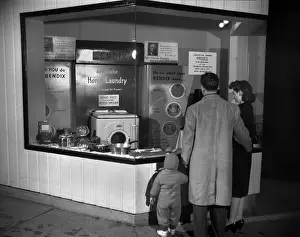 Electricity Prints: Young family look at the Bendix Automatic Home Laundry