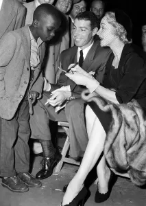 Dietrich Prints: A young fan gets the autographs of Joe DiMaggio and Marlene Dietrich at a Sugar Ray Robinson fight in New York