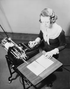 Progress Prints: Young female government employee using an adding machine. Ca. 1935