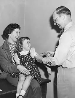 Medical Prints: A young girl receiving a vaccine, circa 1950s. Courtesy: CSU Archives/Everett Collection