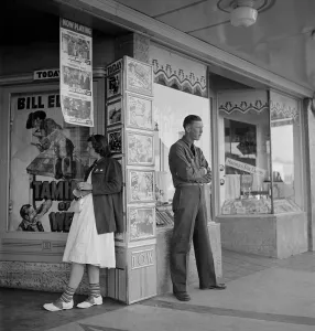 Young Man Prints: Young man and women waiting for the movie house to open in Tulare