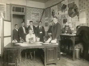 Recruits Prints: Eight young men filling out forms at a U