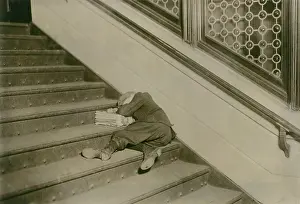Suffering Prints: Very young newsboy sleeps on stairs with papers, Jersey City, New Jersey, Feb. 1912