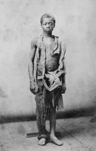 Slaves Prints: Young slave during the civil war reduced to such poverty he is wearing only rags
