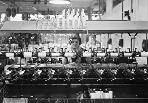 Complexity Prints: Young woman operating a complex modern textile loom in Paterson