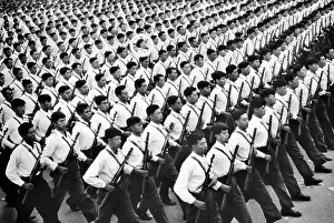 Red China Prints: One young woman soldier (circled) marches among hundreds of men during a parade in in Communist China
