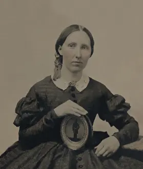 Mourning Prints: Young woman wearing mourning brooch and holding a framed image of unidentified soldier