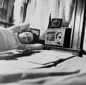 Relaxing Prints: A young women listens to a radio in her Washington D.C. boardinghouse room. 1943