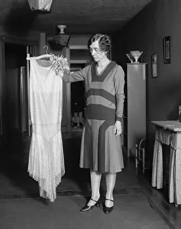 Informal Portraits Prints: Young women quizzically evaluating new dress, May 14, 1925. (BSLOC_2015_16_248)