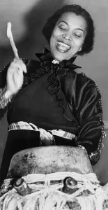 Zora Neale Hurston (1891-1960), African American author and folklorist, beating the hountar, or mama drum. 1937